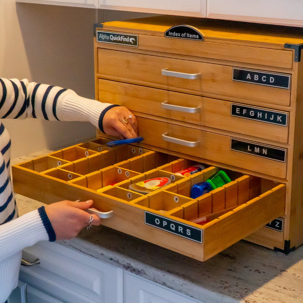 Person opening an Alpha QuickFind drawer full of organized small items